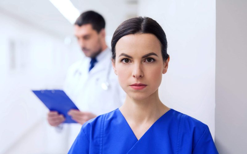 doctor or nurse at hospital corridor healthcare, profession, people and medicine concept - doctor or nurse at hospital corridor